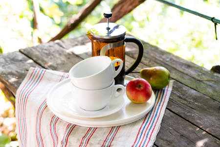 Breakfast serving for two, tea cups and fruitsの写真素材