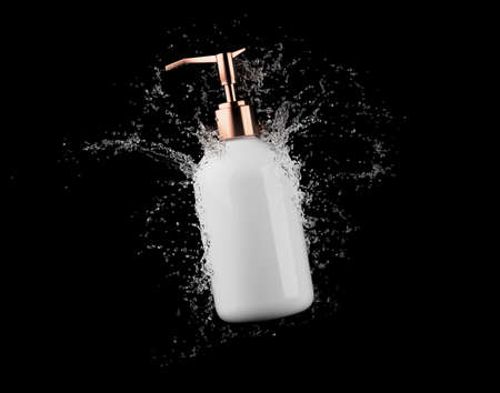Cosmetic white bottle in water splash isolated on black background 3D render, hair and bory care products packaging and brandingの写真素材