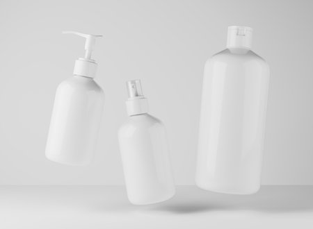 Three different white plastic bottles for hair and body care products 3D render, set of floating cosmetic containers on gray studio background, packaging mockupの写真素材