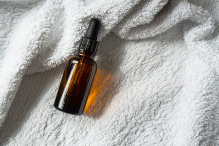 Amber glass serum oil dropper bottle mock-up, cosmetic container daylight shotの写真素材