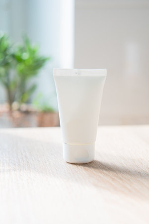 White cream tube in real room interior mock-up, beauty and care product packaging templateの写真素材