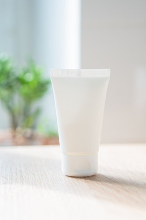 White cream tube in real room interior mock-up, beauty and care product packaging templateの写真素材