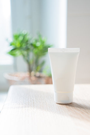 White cream tube in real room interior mock-up, beauty and care product packaging templateの写真素材