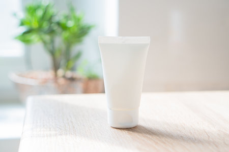 White cream tube in real room interior mock-up, beauty and care product packaging templateの写真素材