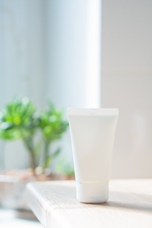 White cream tube in real room interior mock-up, beauty and care product packaging templateの写真素材