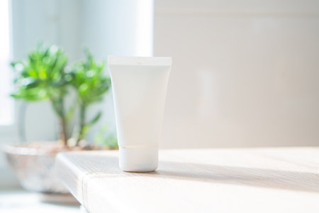 White cream tube in real room interior mock-up, beauty and care product packaging templateの写真素材