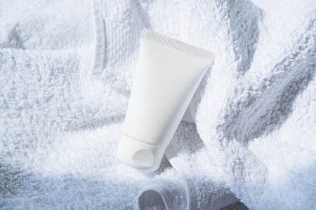 White cream tube on cotton towel mock-up, beauty and care product packaging templateの写真素材