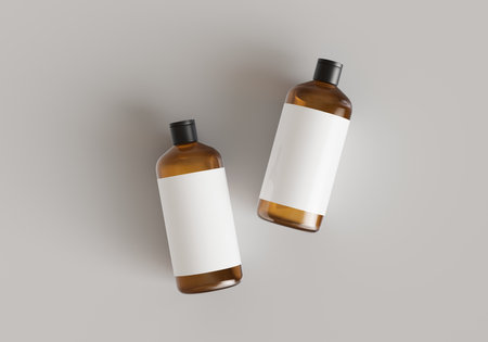 Two brown plastic cosmetic containers with labels, shampoo bottles laying on gray background front view 3D render mockupの写真素材
