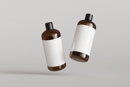 Two brown plastic cosmetic containers with labels, shampoo bottles floating on gray background front view 3D render mockupの写真素材