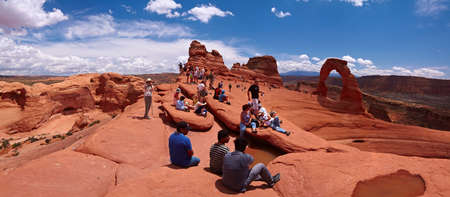 Arches National Park, Utah, USA - May 24, 2009 - Tourists gazing at the Delicate Archのeditorial素材