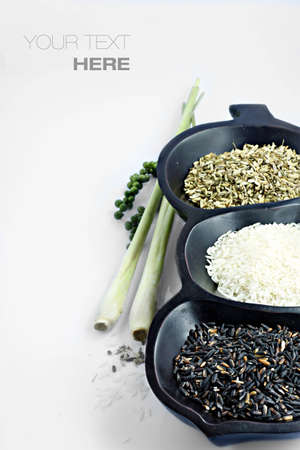 3 kinds of rice in wooden tray over white background with sample textの写真素材