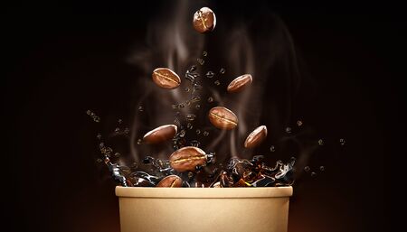 Hot takeway espresso morning coffee in cardboard paper cup. Coffee to go fragrant drink splashes with falling down coffee beans and steam on black background. Banner design 3d rendered illustration.の写真素材