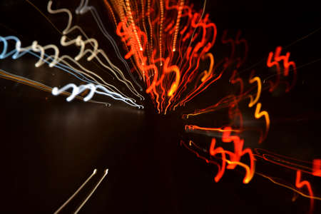 Colorful street lights by night. Blurred city lights at night. Dizzy street lights at night.
