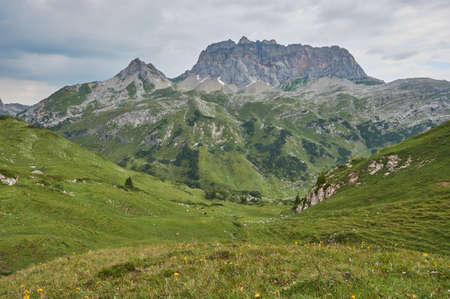 Beautiful panoramic mountain landscape in Austria. Lonely panoramic mountain landscape in the alps. Rocky mountain peak in between green meadows.の写真素材