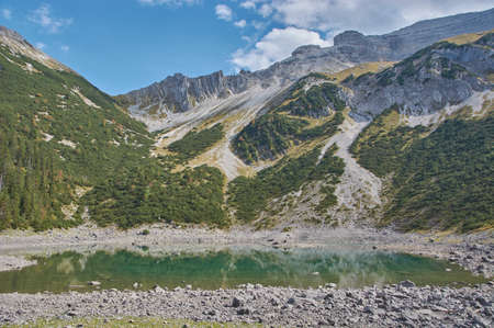 Beautiful mountain lake in the bavarian alps. Panoramic mountain landscape with a reflecting mountain lake in the bavarian alps.の写真素材