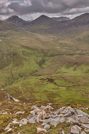 Panoramic view from a mountain in the Connemara National Park, Ireland. Hiking through the mountains in Connemara National Park, Ireland.の写真素材