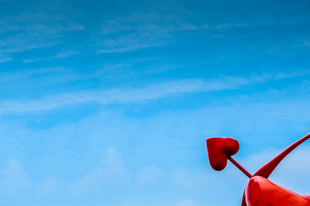 Red herat sculpture pointing to the skyの写真素材