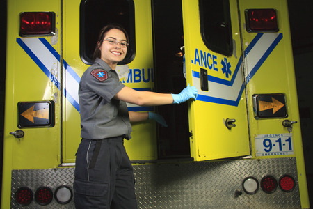 A paramedic, on the back door of the ambulance.の写真素材