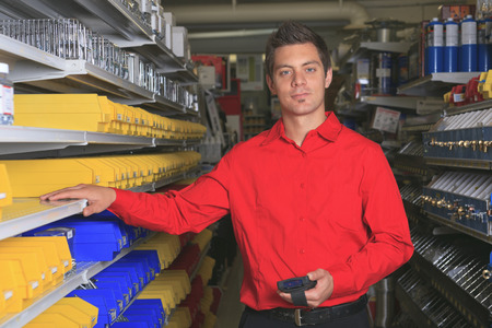 A employee of a hardware store at work.