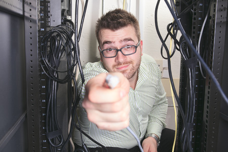 A happy worker technician at work with computer.