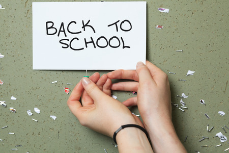 University / college student girl looking happy smiling with book or notebook in campus park. Beautiful young Caucasian young woman female model.の写真素材