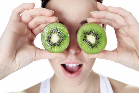A beautiful training woman with fruit backgroundの写真素材
