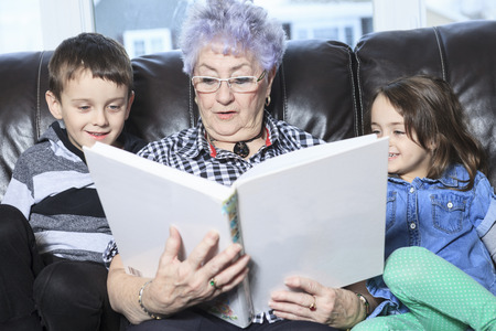 Portrait of smiling multigeneration family spending leisure time together at homeの写真素材