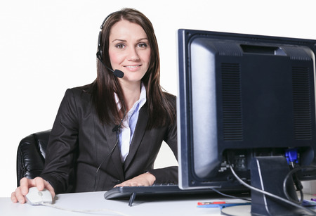 Young pretty business woman with computer in the officeの写真素材