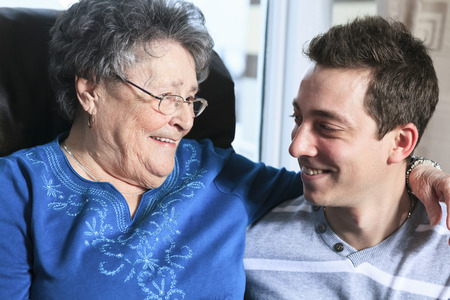 A grandchild with his grandmother in his roomの写真素材