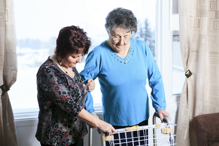 A daughter with is mother help with walkerの写真素材