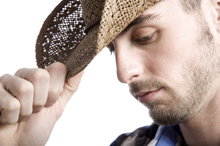 classic male cowboy portrait in front of a white backgroundの写真素材