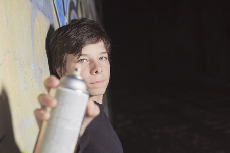 A teen made some graffiti on the wall of a tunnel