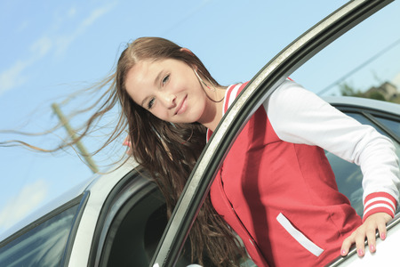 Car driver woman happy showing car keys out windowの写真素材