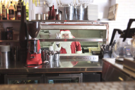 A Santa claus smiling in undustrial kitchenの写真素材