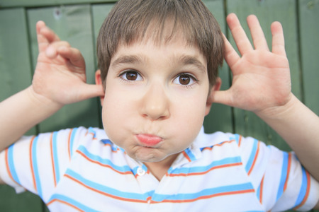 A boy with a funny face expressionの写真素材