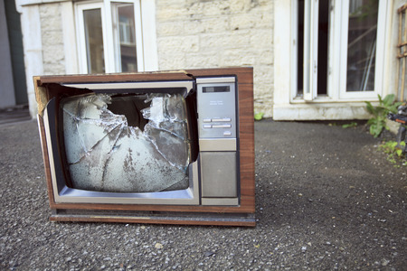An old broken TV left on the street.の写真素材