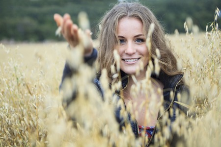 A Beautiful young woman portrait in hay field.