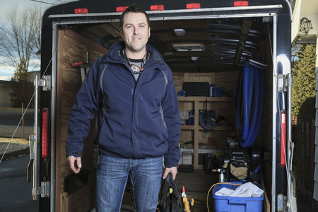 A Portrait of an happy worker with tool