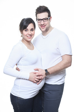 A Portrait of happy pregnant woman isolated over white backgroundの写真素材
