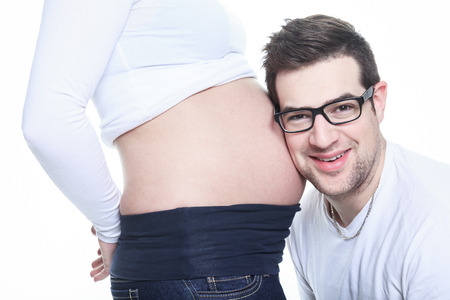 A Portrait of happy pregnant woman isolated over white backgroundの写真素材
