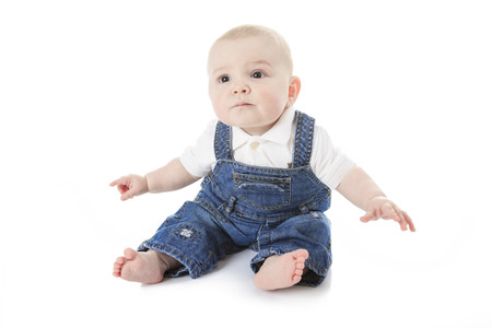 cute little baby creeping and smiling isolated on white