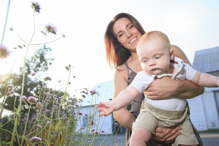 A mother with is baby on a beautiful forestの写真素材