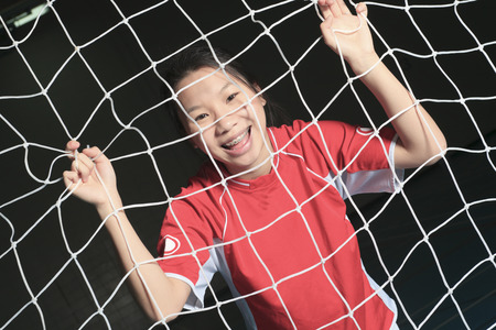 A female soccer player in a stadiumの写真素材