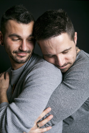 A gay couple on black studioの写真素材