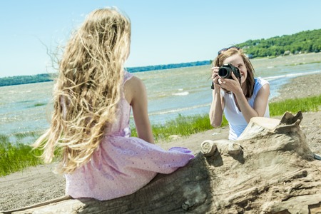 A Cheerful mother taking picture of her cute little daughter.の写真素材