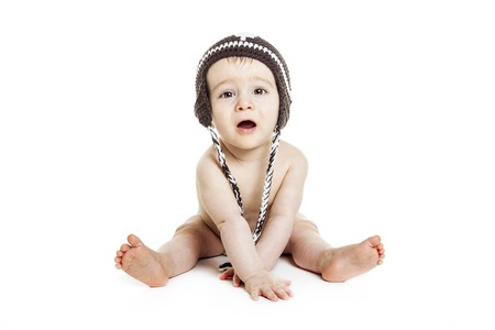 A Sweet little boy sitting on the studio withwinter capの写真素材