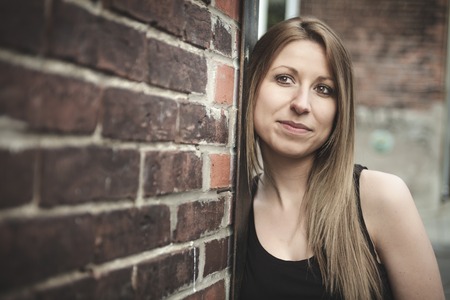 A Beautiful modern girl near the brickwall.
