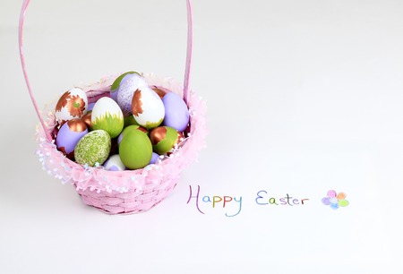 A Easter eggs in the basket over white backgroundの写真素材