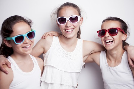 Tree beautiful best friend teen with sunglasses over gray backgroundの写真素材