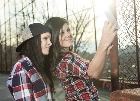 A siter holding a cellphone taking selfieの写真素材